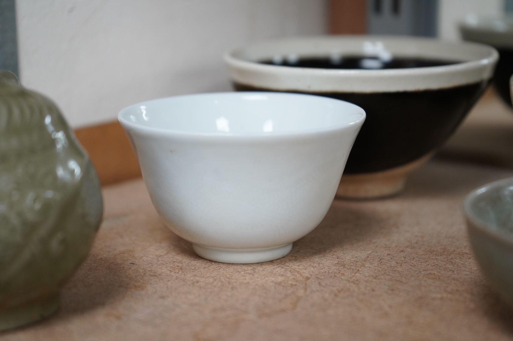 A collection of Chinese porcelain and pottery to include a naturalistic teapot, crackle glaze bowl and a ‘dragon’ bowl, largest 10cm in diameter